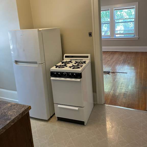 a white refrigerator and stove in a kitchen.