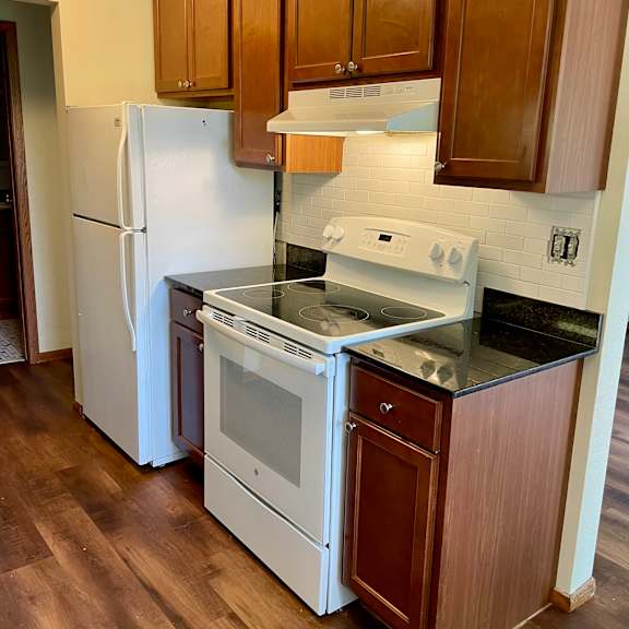kitchen with updated cabinets, granite countertops, and dishwasher.