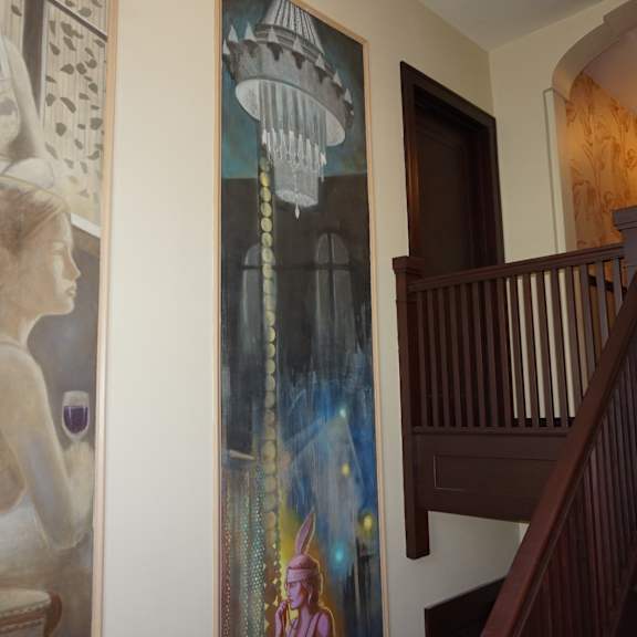 a painting of a woman is on the wall.