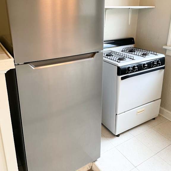 full-sized appliances including new stainless steel fridge.