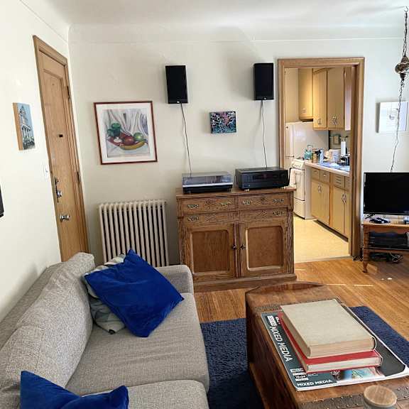 a living room with a grey couch and a wooden coffee table.