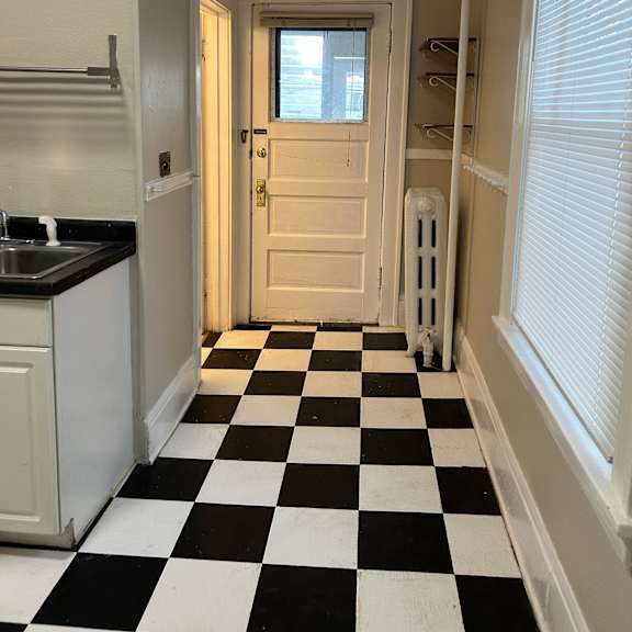 a black and white checkered floor in a kitchen.