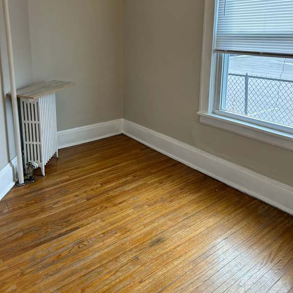 a room with a window and a radiator.