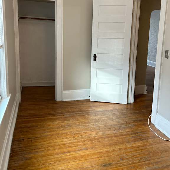 a room with a white door and a window.