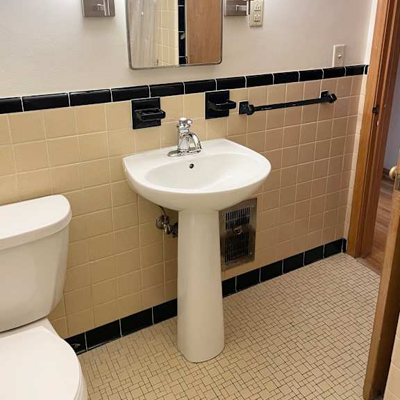 classic vintage deco-tiled bathroom.