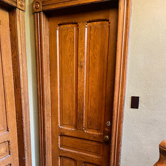 a wooden door with a handle and a keyhole.