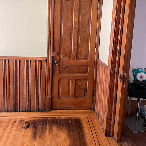 a wooden cabinet with a drawer and a door.