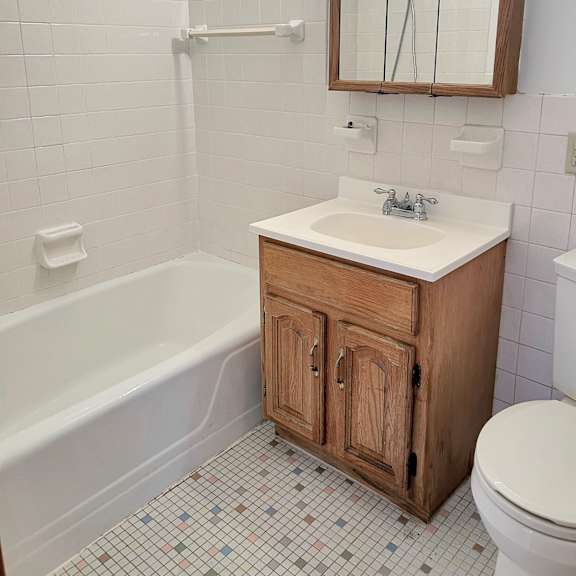 a white sink is on a wooden cabinet in a bathroom.