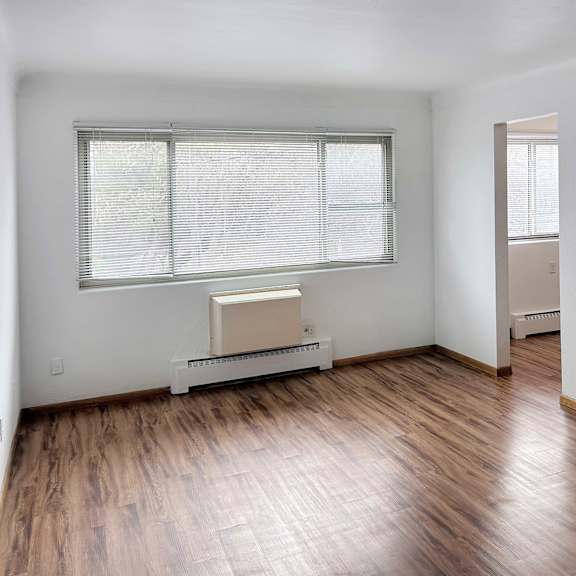 a room with a window and a radiator on the floor.
