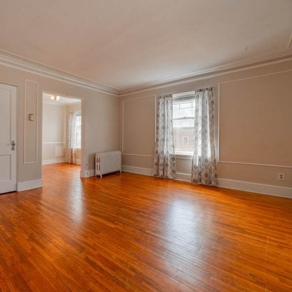 a room with wooden floors and white walls.