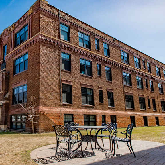 a red brick building with a table and chairs outside.