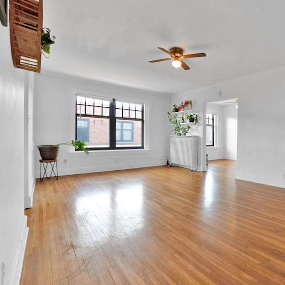 a room with wooden floors and a ceiling fan.