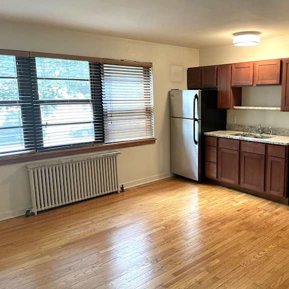 a kitchen with wooden floors and stainless steel appliances.