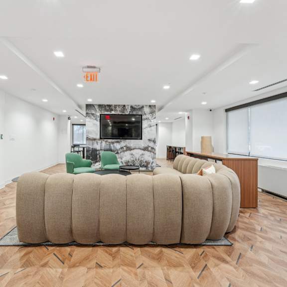 a room with a large round couch and a television at sherwood at southern towers, alexandria, 22311