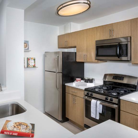 kitchen with stove top oven at the graham at southern towers, alexandria, virginia, 22311