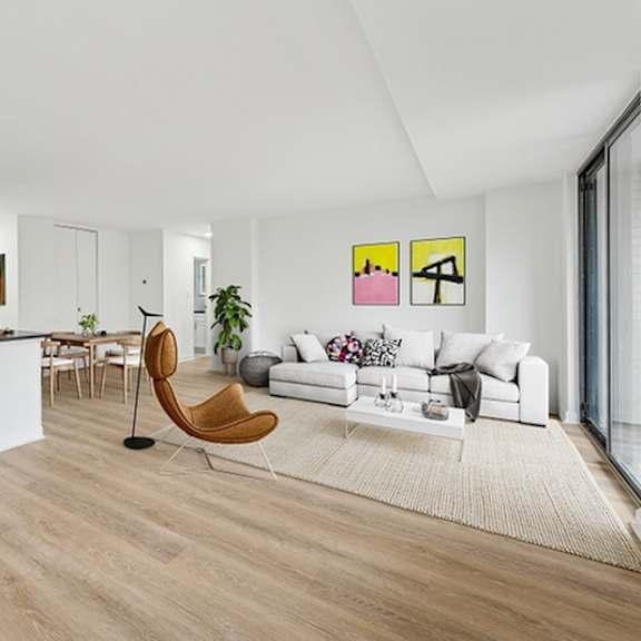 a modern living room with a white couch and a wooden chair.at sherwood at southern towers, alexandria, 22311