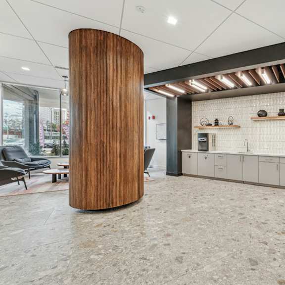 a modern office lobby with a wooden column and a row of lockers at sherwood at southern towers, alexandria, 22311