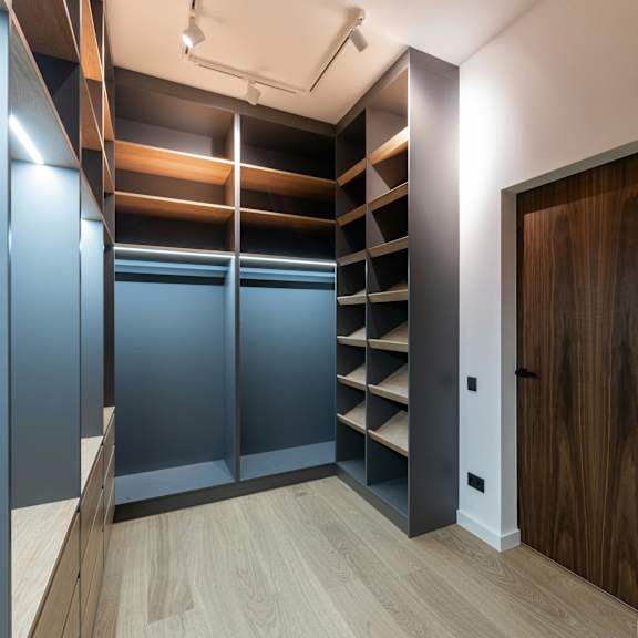 a room with a wooden floor and a brown door.