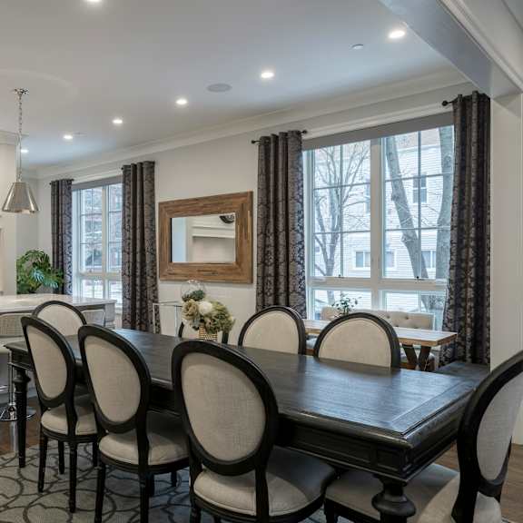 a modern kitchen with a dining table set for four.