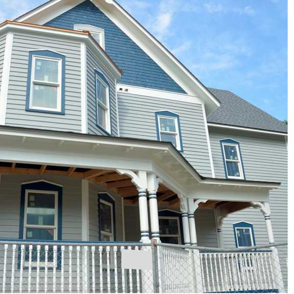 a blue house with white trim and a porch.