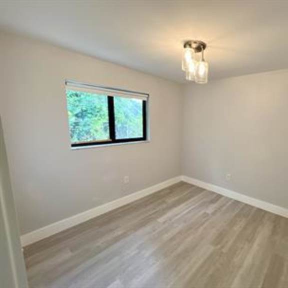 a room with a window and a light on the ceiling.