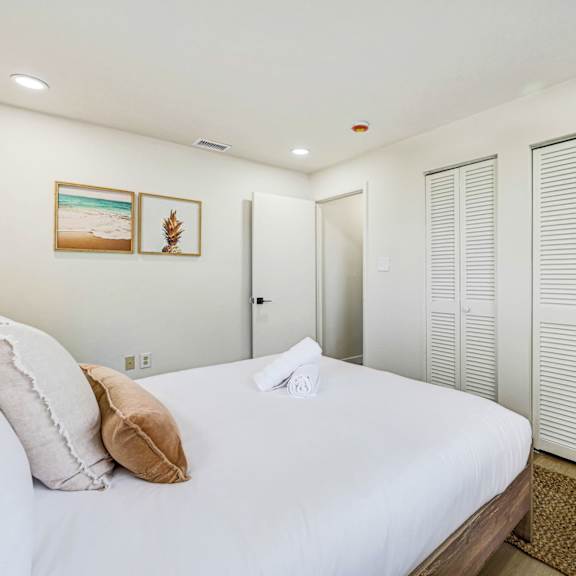 a bedroom with a large bed and a wardrobe.