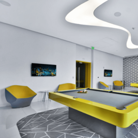 a pool table in a room with a yellow and black color scheme.