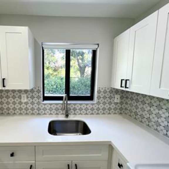 a kitchen with a sink and cabinets.