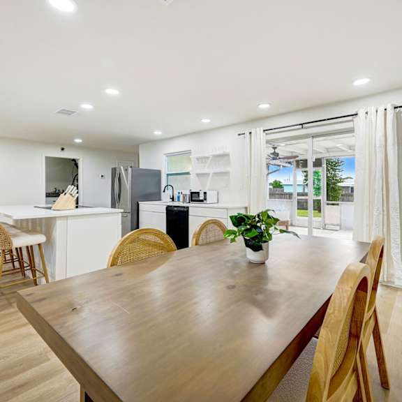 a dining room with a wooden table and chairs.