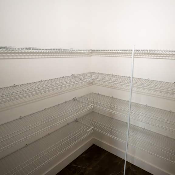 empty white shelves in a room.