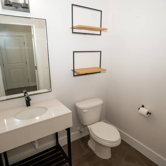 a white sink and toilet in a small bathroom.