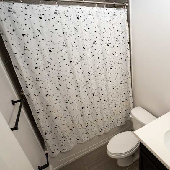a white toilet sits next to a sink in a small bathroom.