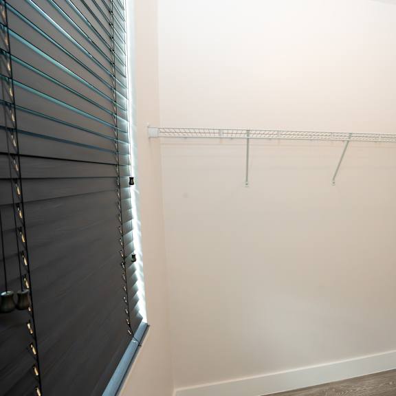 a white wall with a metal rack on it.