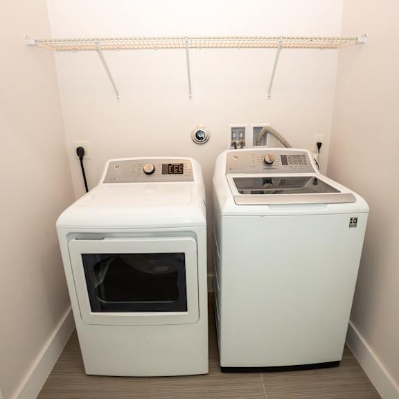 two white ovens in a small room.