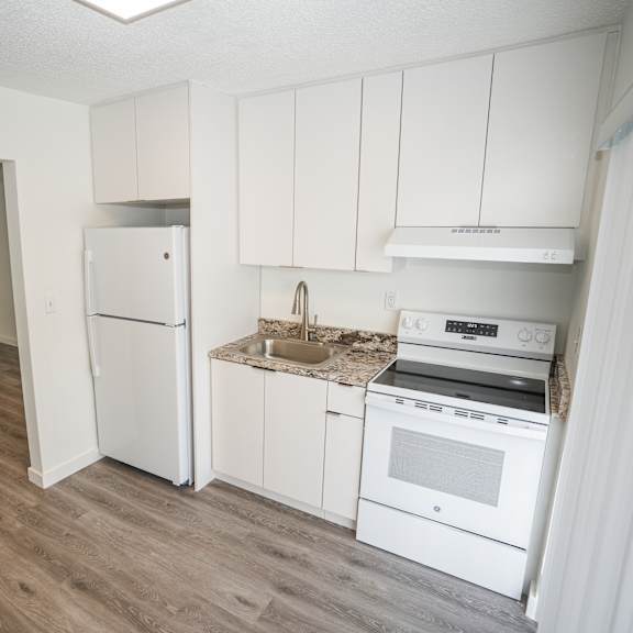 a kitchen with white appliances and cabinets.