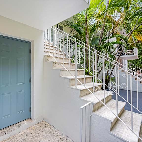 a blue door with a number 1 on the wall above it.
