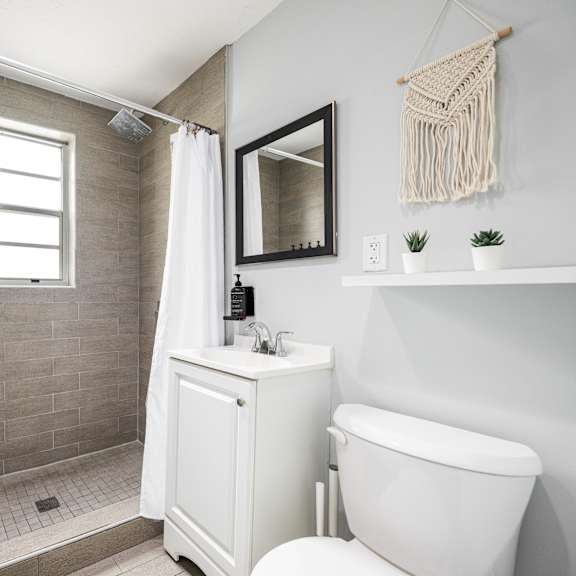 a bathroom with a white tub and a shower with a glass door.