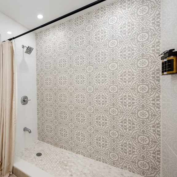 a bathroom with a shower and towel rack.