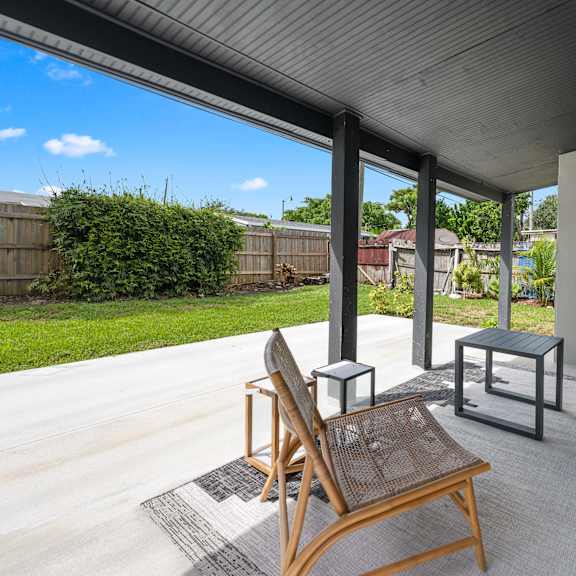 a patio with a chair and a table.