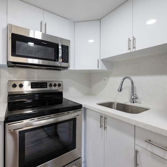 a modern kitchen with a stove, oven, and microwave.