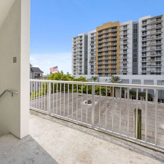 a balcony with a metal railing and a concrete floor.