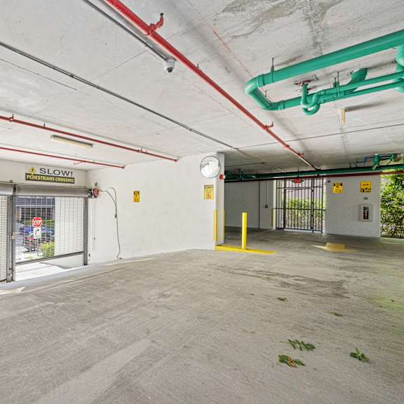 a parking garage with a sign that says "slow".