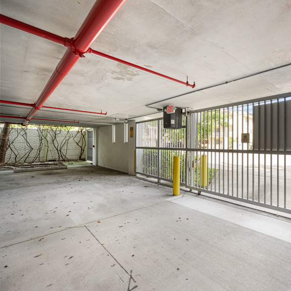 a large, empty parking garage with a red and white striped gate.