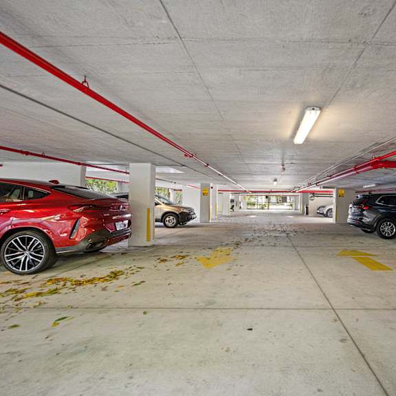 a red car is parked in a parking garage.