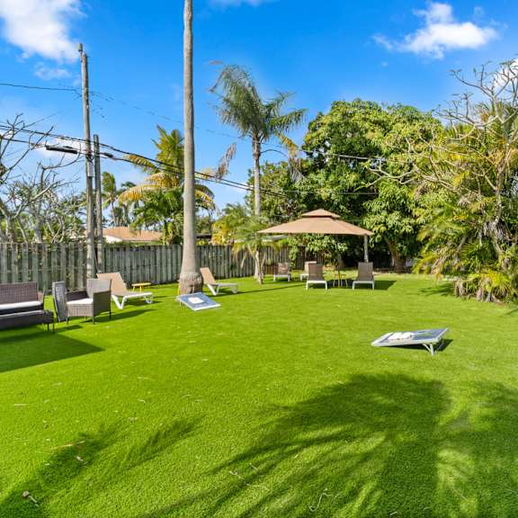 a backyard with a lawn and a gazebo.