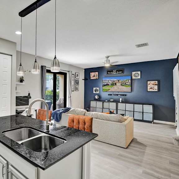 a modern kitchen with a black countertop and a dishwasher.
