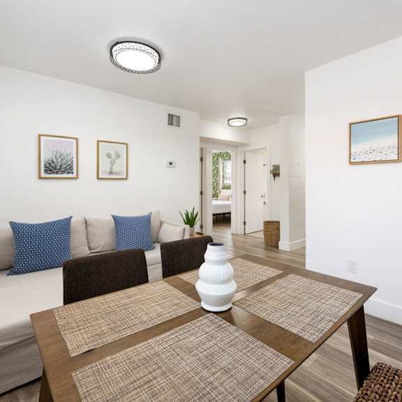 a dining room with a brown table and a white couch.
