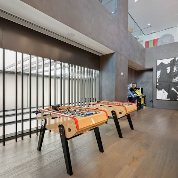 a room with a long table and chairs with a person in the background.