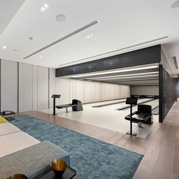 a modern living room with a grey sofa and yellow accent pillows.