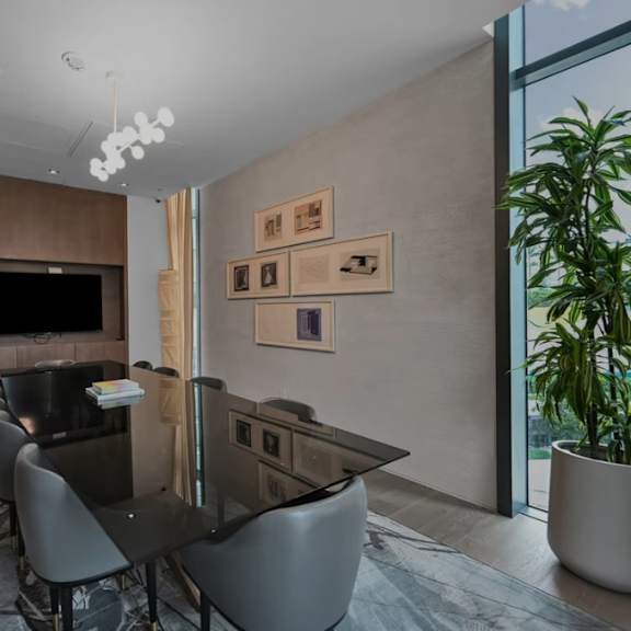 a modern dining room with a long table and chairs.